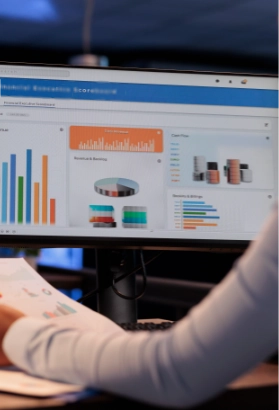 Office employee analyzing business charts on computer