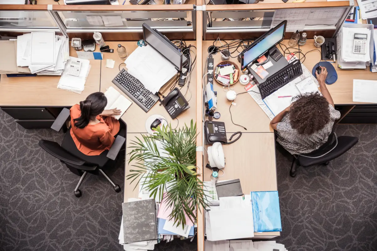 Overhead view of two businesswomen at office desk
