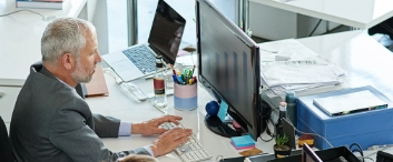 Shot of colleagues working on their computers while sitting in an office
