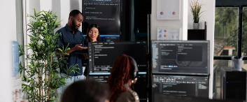 Software programmers discussing about algorithms on big screen