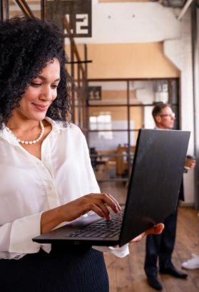 Women using a laptop in office to speak to IT Vendors