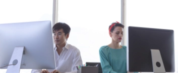 business people working on computer at desk in modern office