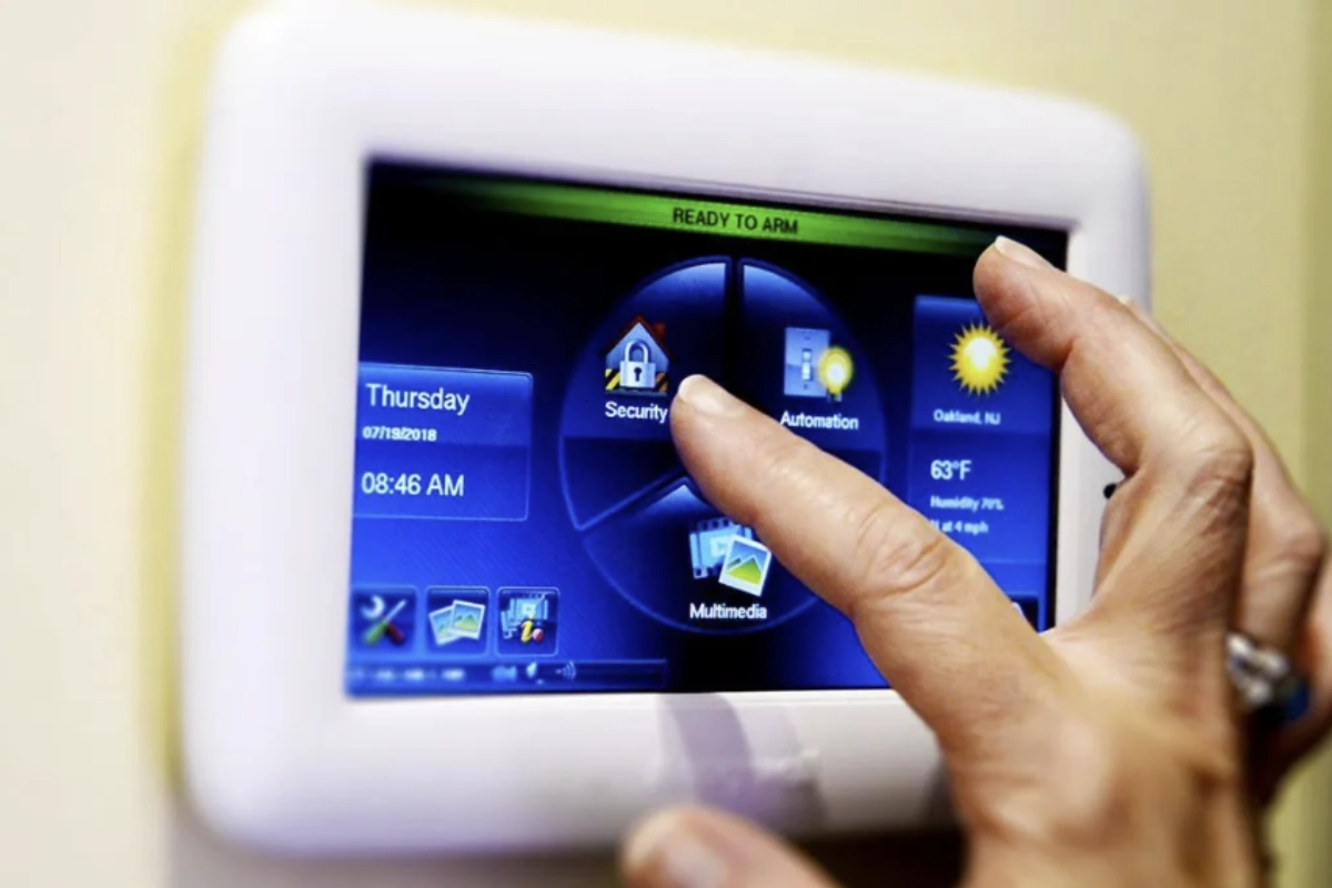 Close up shot of a woman using a security control hub