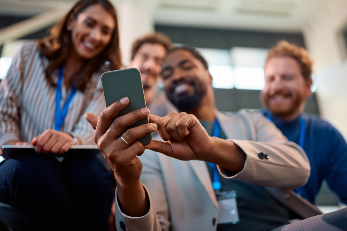 taking selfie with is coworkers during a business conference.