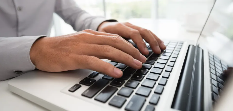 man-working-on-laptop-in-daylight-